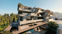 View of a private residence overlooking at the living room and rooftop levels. Exposed concrete, spacious lounging, with a neo-Brutalist vibe. Image copyright: Karydis & Associates.