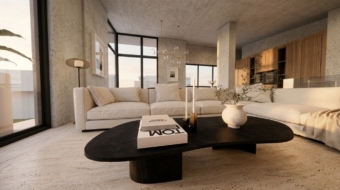 Contemporary interior space with exposed concrete surfaces, windows from floor to ceiling, travertine flooring, off-white sectional sofa and oak kitchen cabinetry in the background. Image copyright: Karydis & Associates.