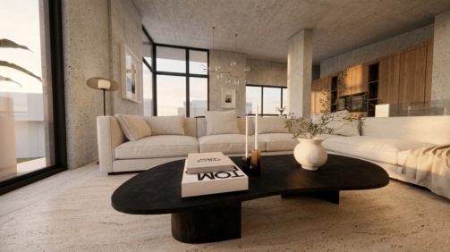 Contemporary interior space with exposed concrete surfaces, windows from floor to ceiling, travertine flooring, off-white sectional sofa and oak kitchen cabinetry in the background. Image copyright: Karydis & Associates.