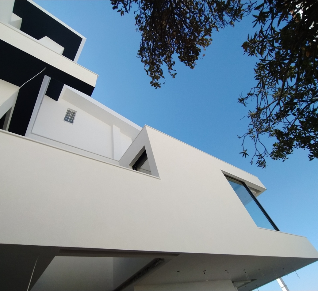 View of a private residence from below looking up at the side facade, during the final stage of construction. Image copyright: Karydis & Associates.